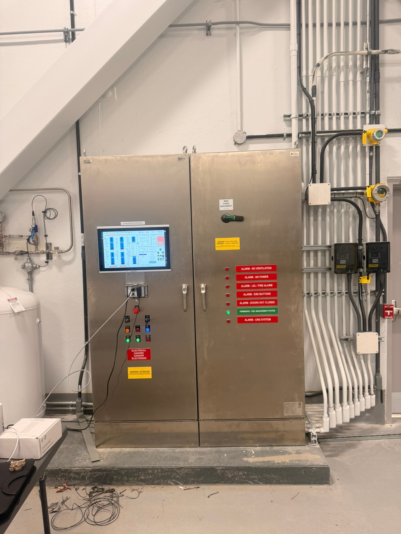 Control panel with HMI screen active and alarm status indicators