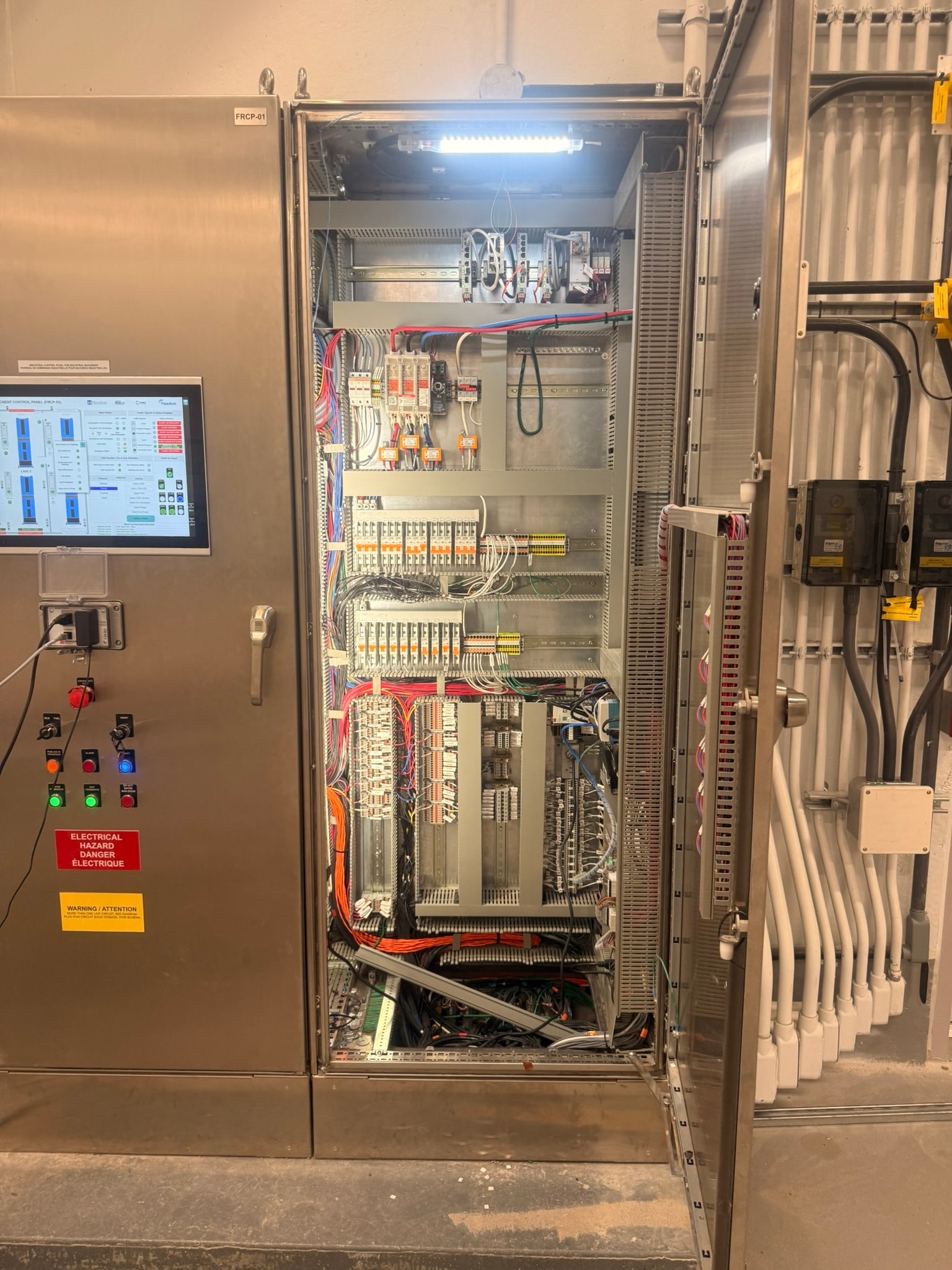 Interior panel wiring — single door open showing PAC, Safety PLC and terminal blocks